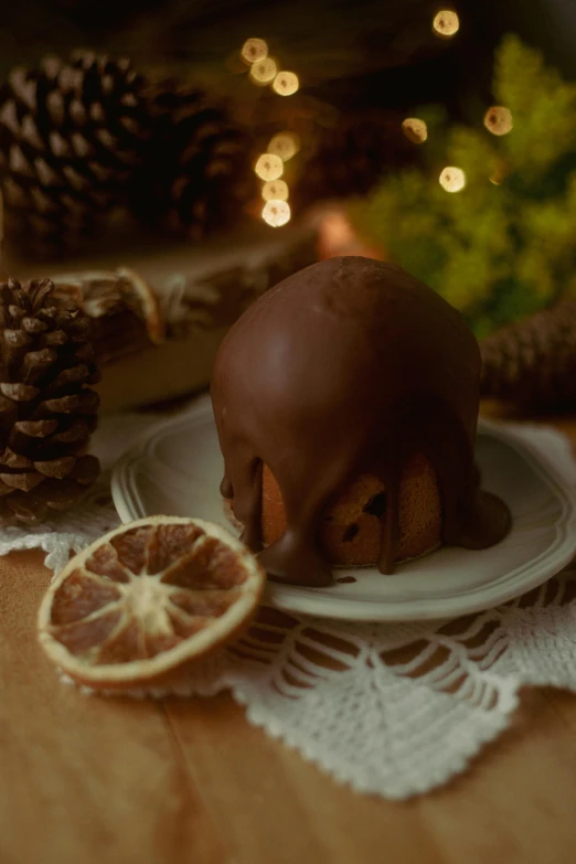 a chocolate covered head is on a plate with oranges