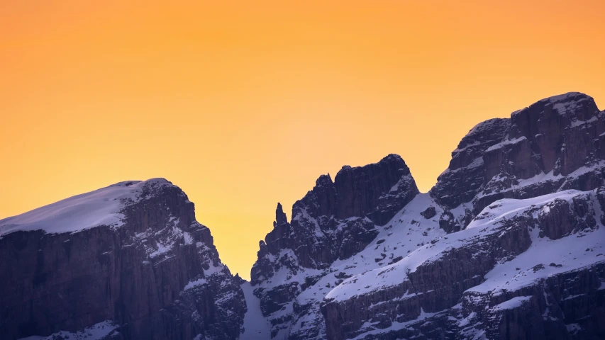 an image of mountain top with snow on it