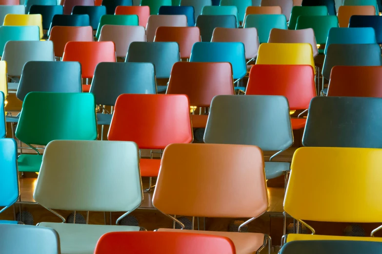 rows of colored chairs stacked on top of each other