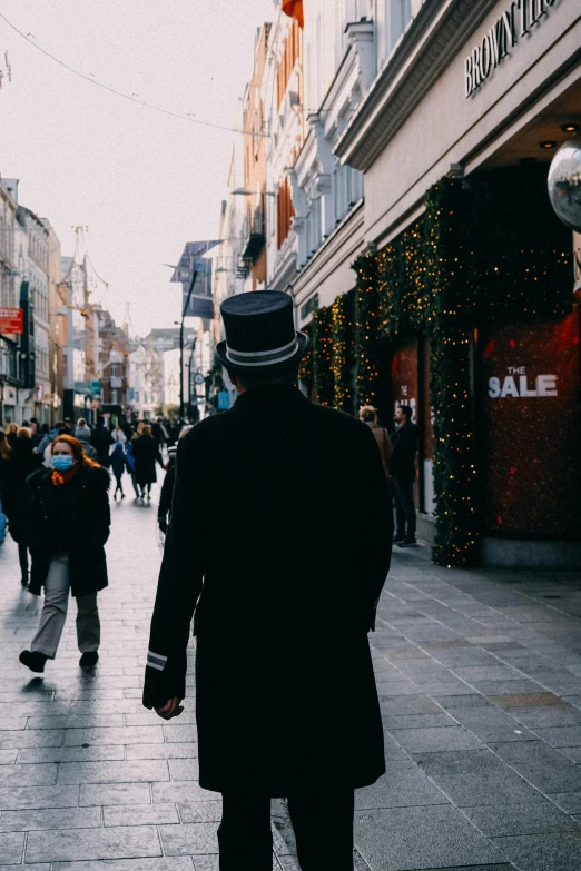 an older man walking down a street with a crowd of people