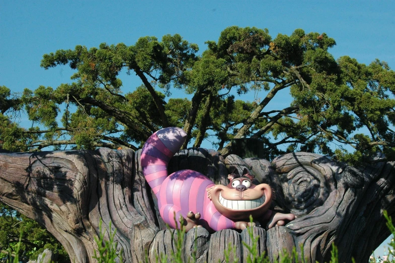 a pink caterpillar is in a tree on a park