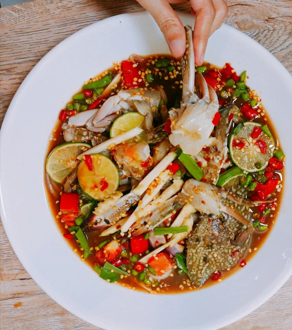 a plate topped with chicken and vegetables on top of a table