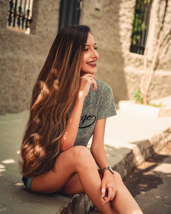 a girl is sitting on steps smiling at someone