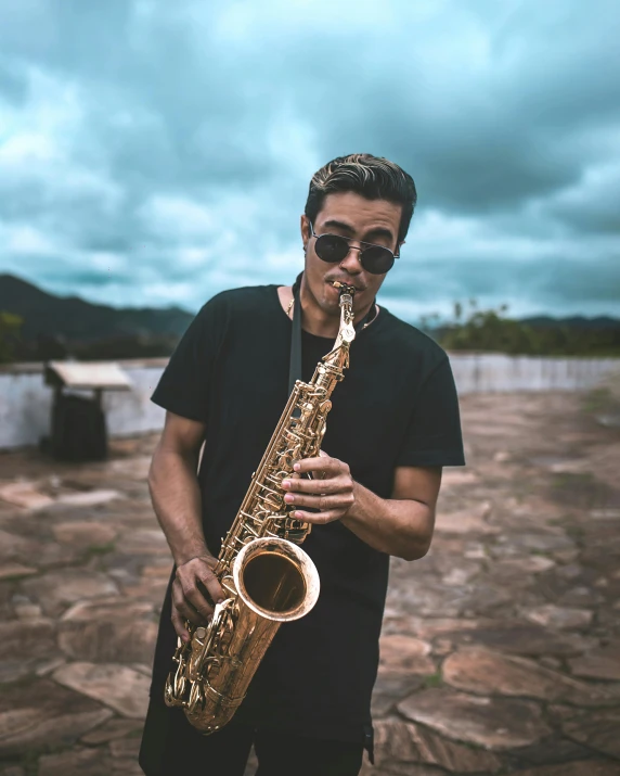 a man playing a saxophone on the ground