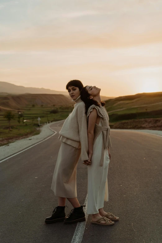 two women are crossing the street in front of each other