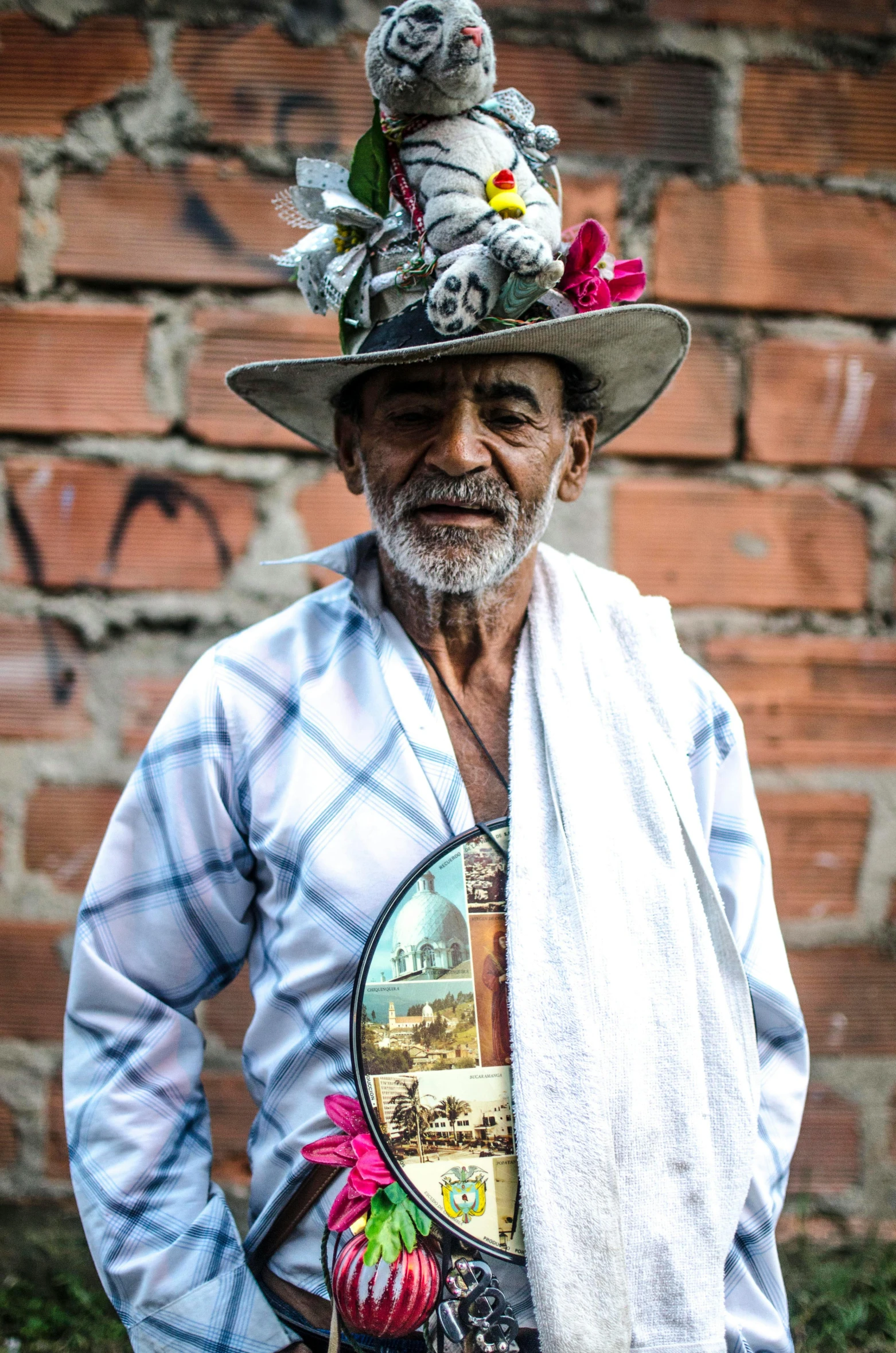 a man with a hat and scarf poses for a po