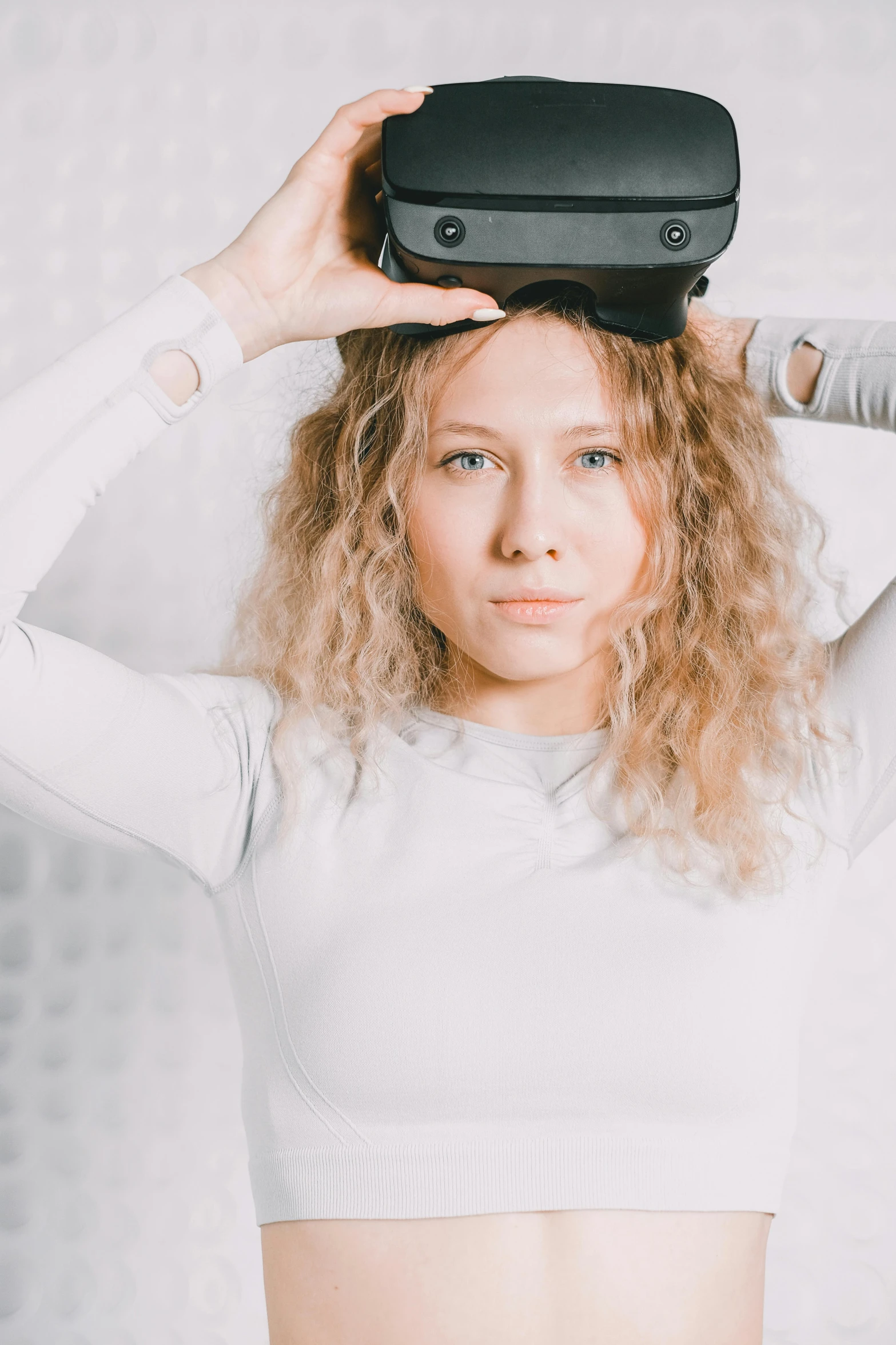 a woman holding an object over her head