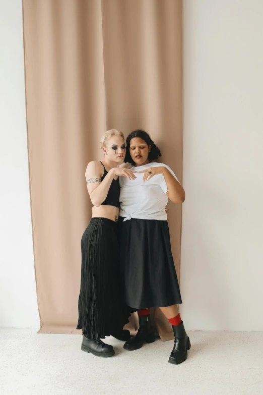two women pose with their arms around each other