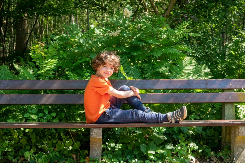 a  sitting on top of a park bench