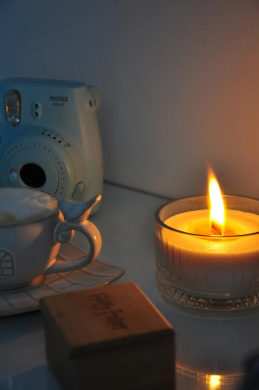 a candle is lit next to a camera