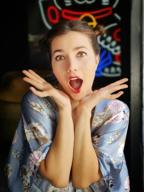 a woman wearing a kimono making a shocked face