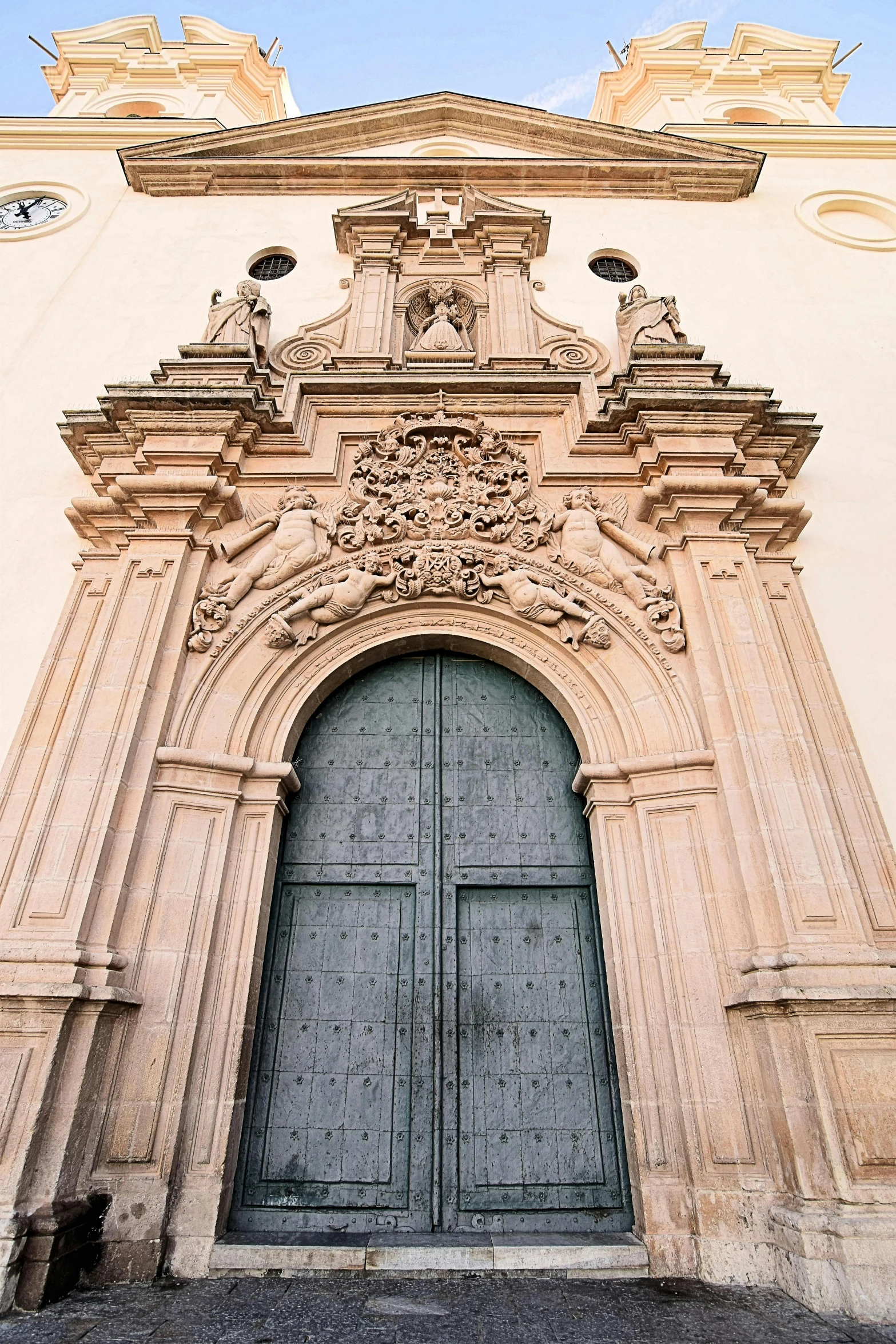 two doors in front of an ornate church