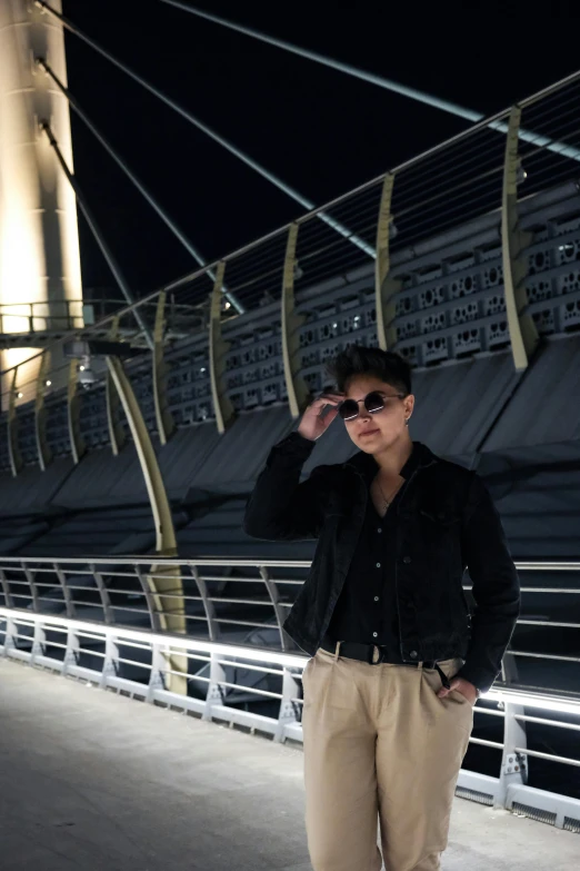 a man with sunglasses standing on the boardwalk