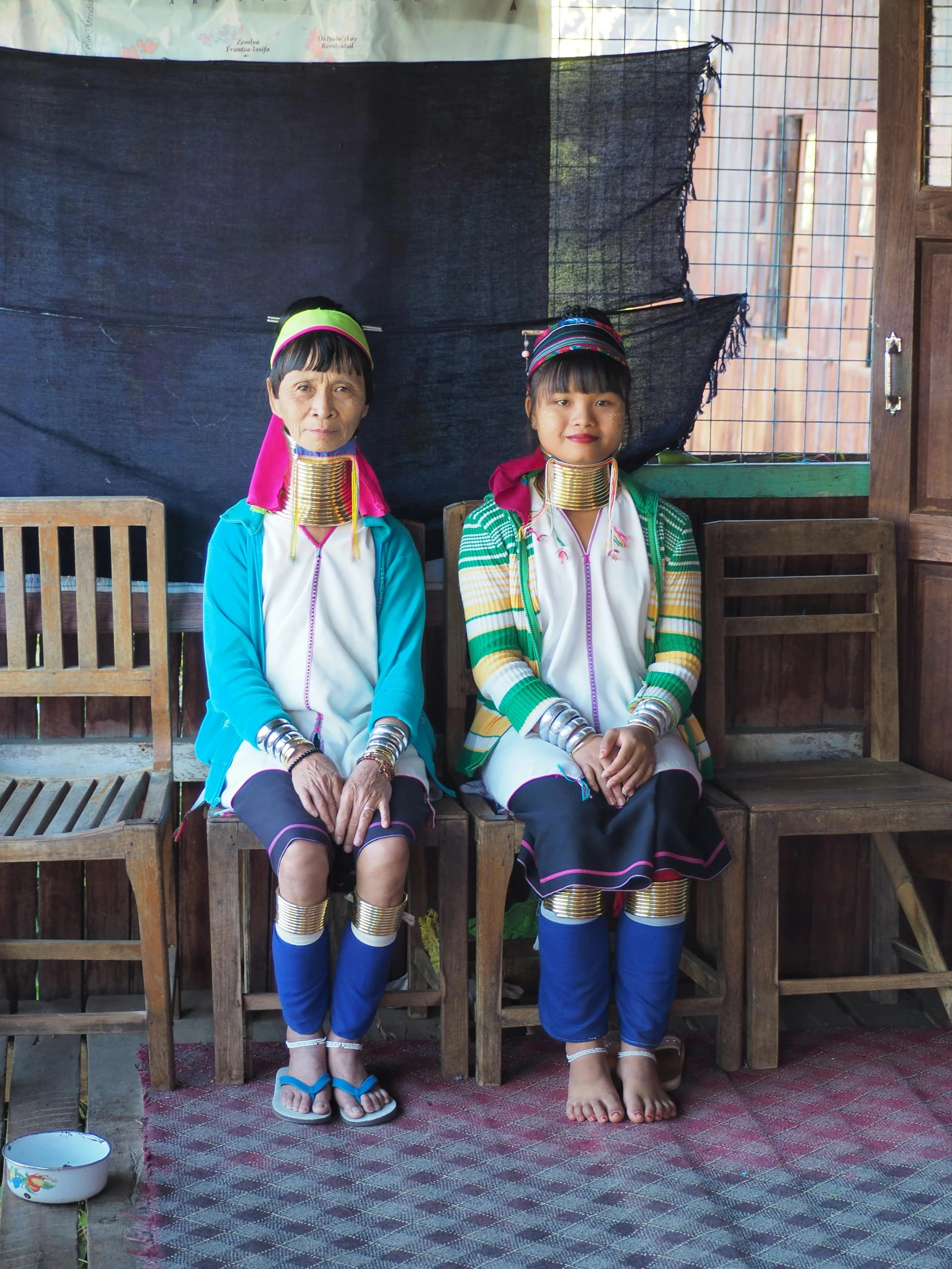 two children in costumes sit on chairs