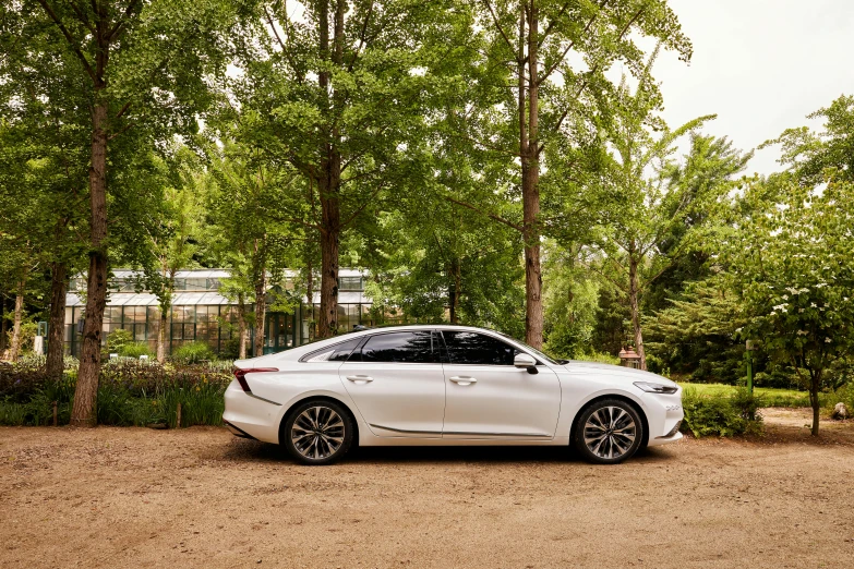 a bmw glaxe parked in front of some trees