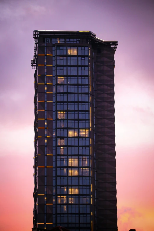 a tall building is lit up in the night sky