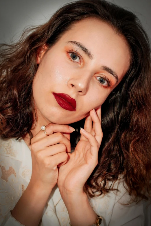 a woman with brown hair wearing red lipstick