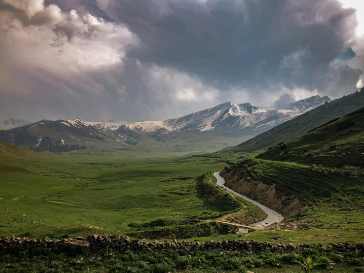 a long winding country road surrounded by rolling green hills