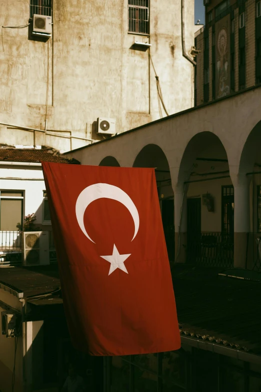 a red turkish flag flying in the wind