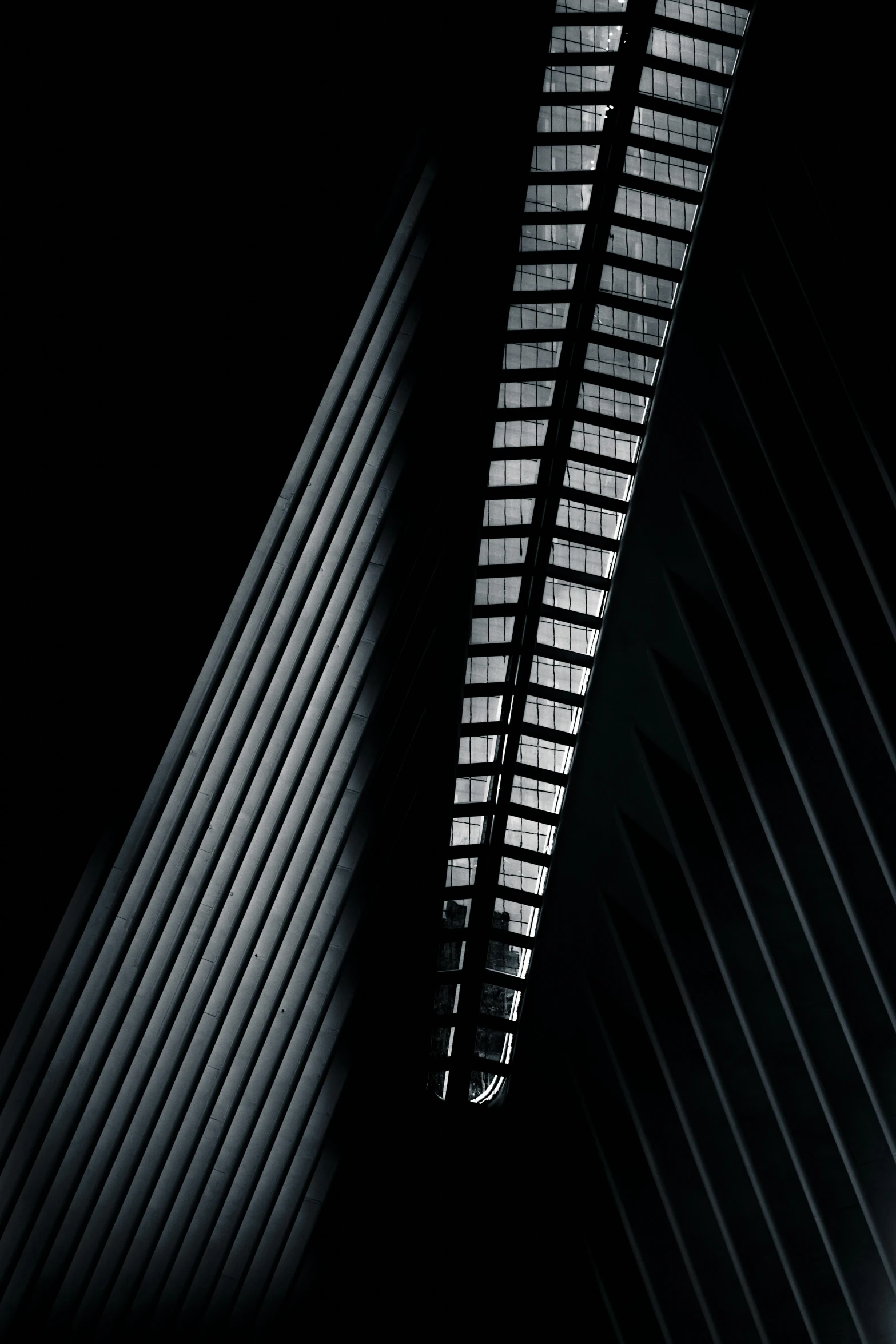 two tall buildings standing next to each other in the dark