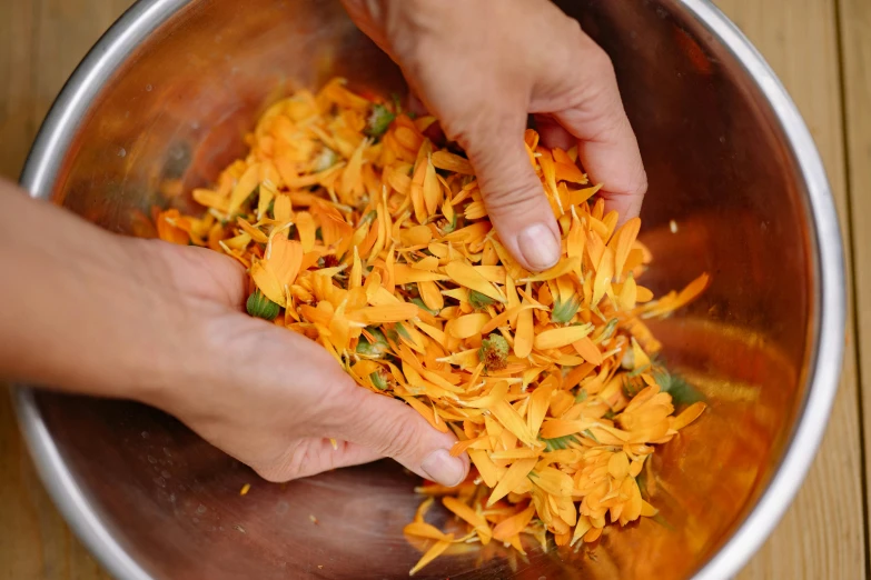 someone is scooping saffron from a bowl on the table