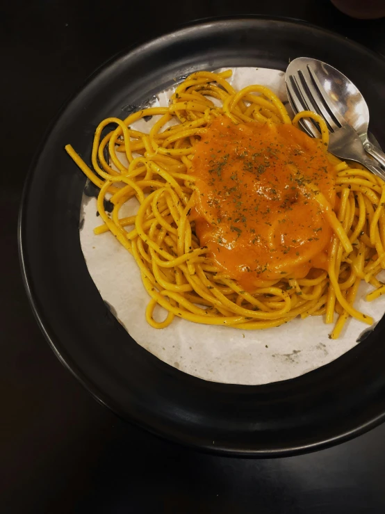 a plate topped with pasta covered in sauce