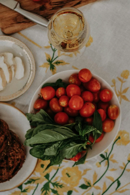 a plate filled with food next to a bowl of vegetables