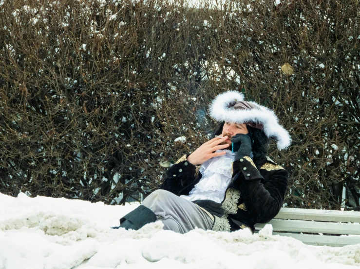 a person is sitting on a bench in the snow