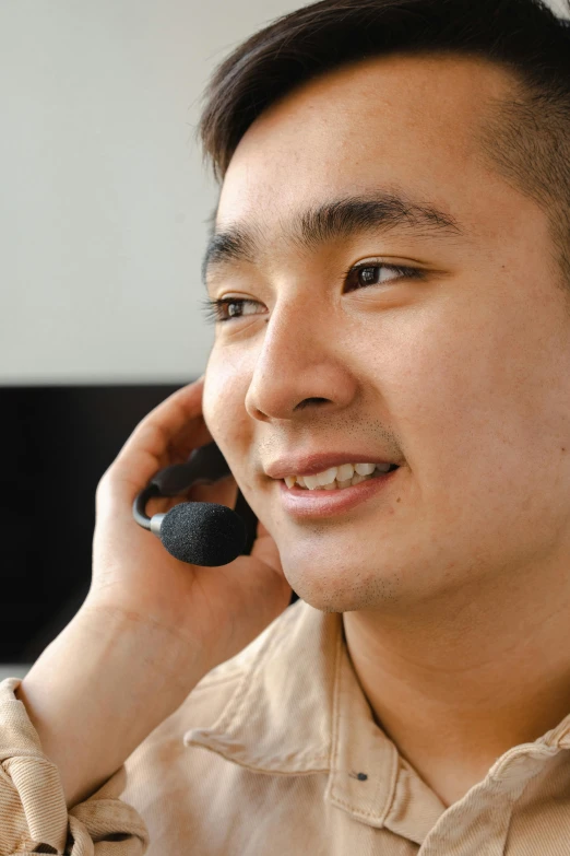a smiling man talking on a cell phone
