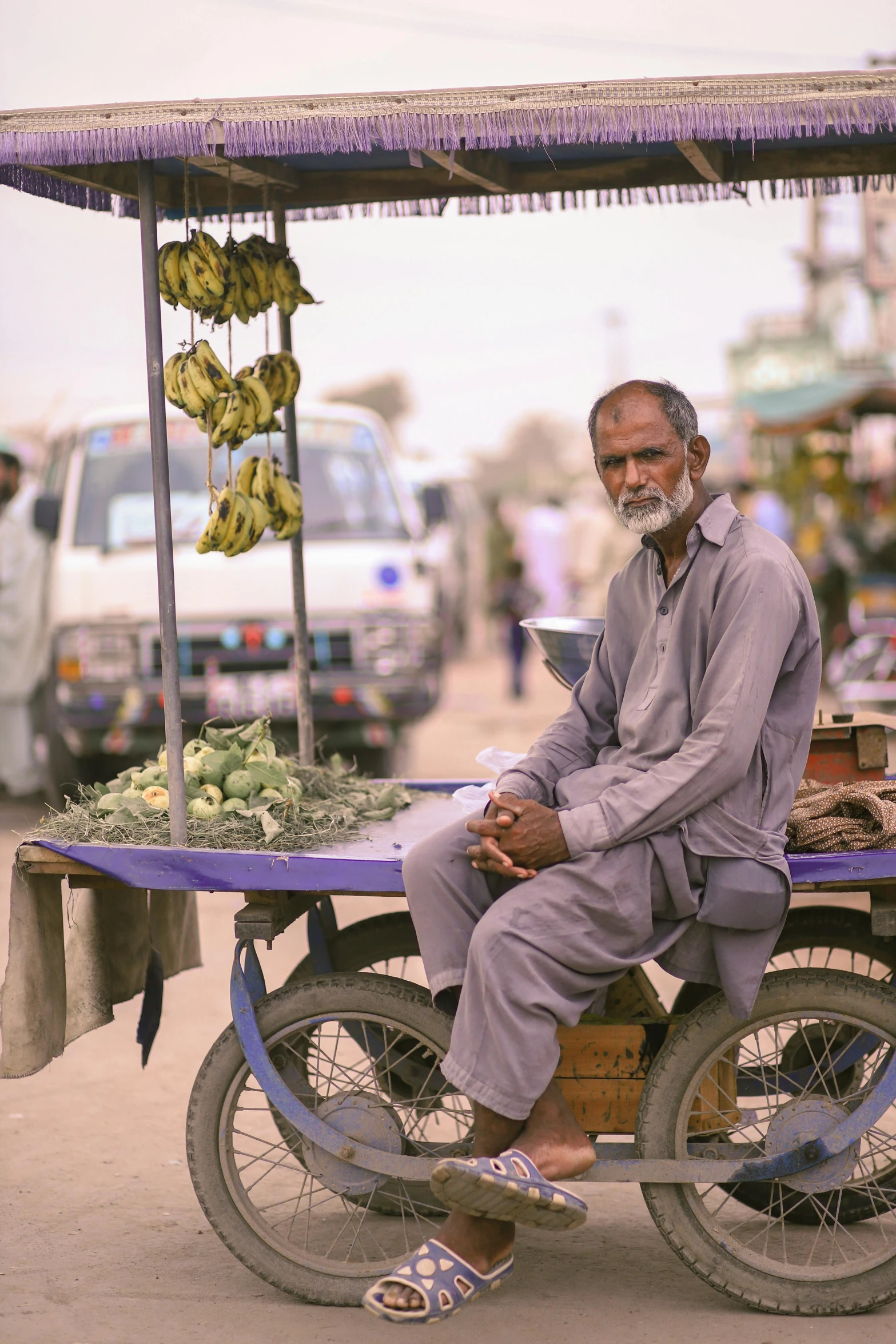 an elderly man is sitting on the side of his bike