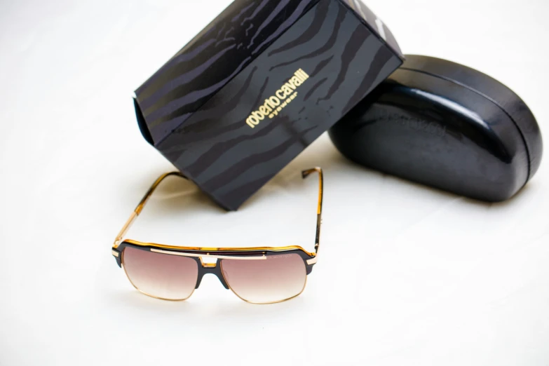 a pair of sunglasses sitting next to a box