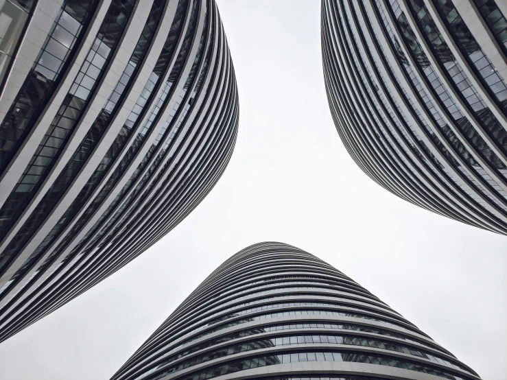 a view of two tall buildings from below