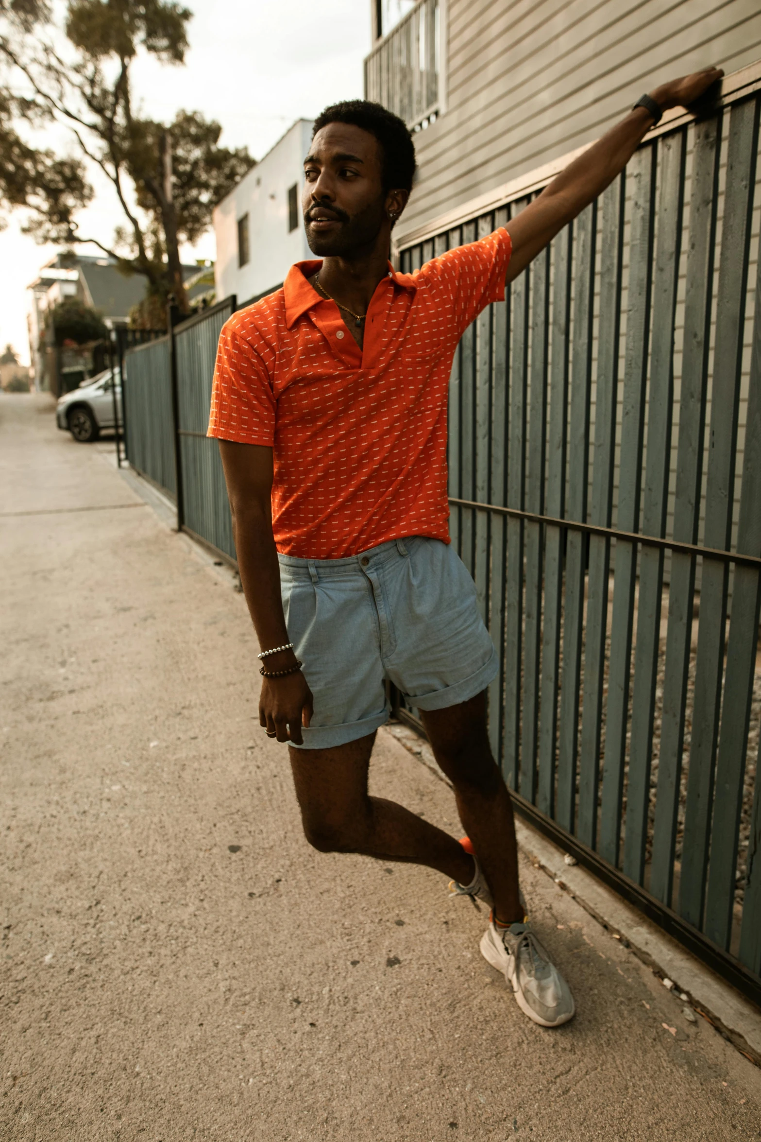 an african american male is leaning against the wall