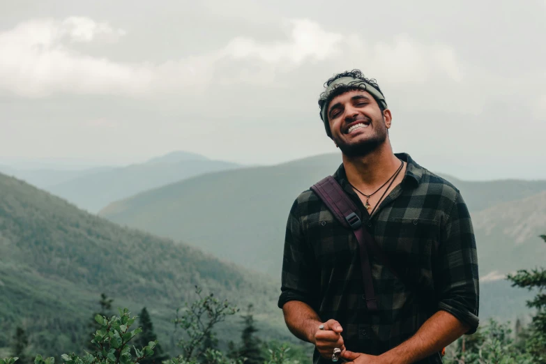 man in the mountains looking at the camera