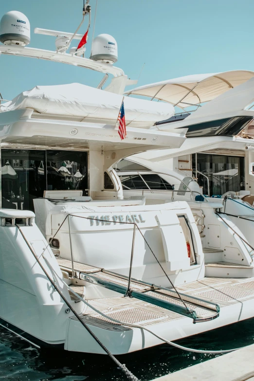 several white boats sitting on the dock at a boat show