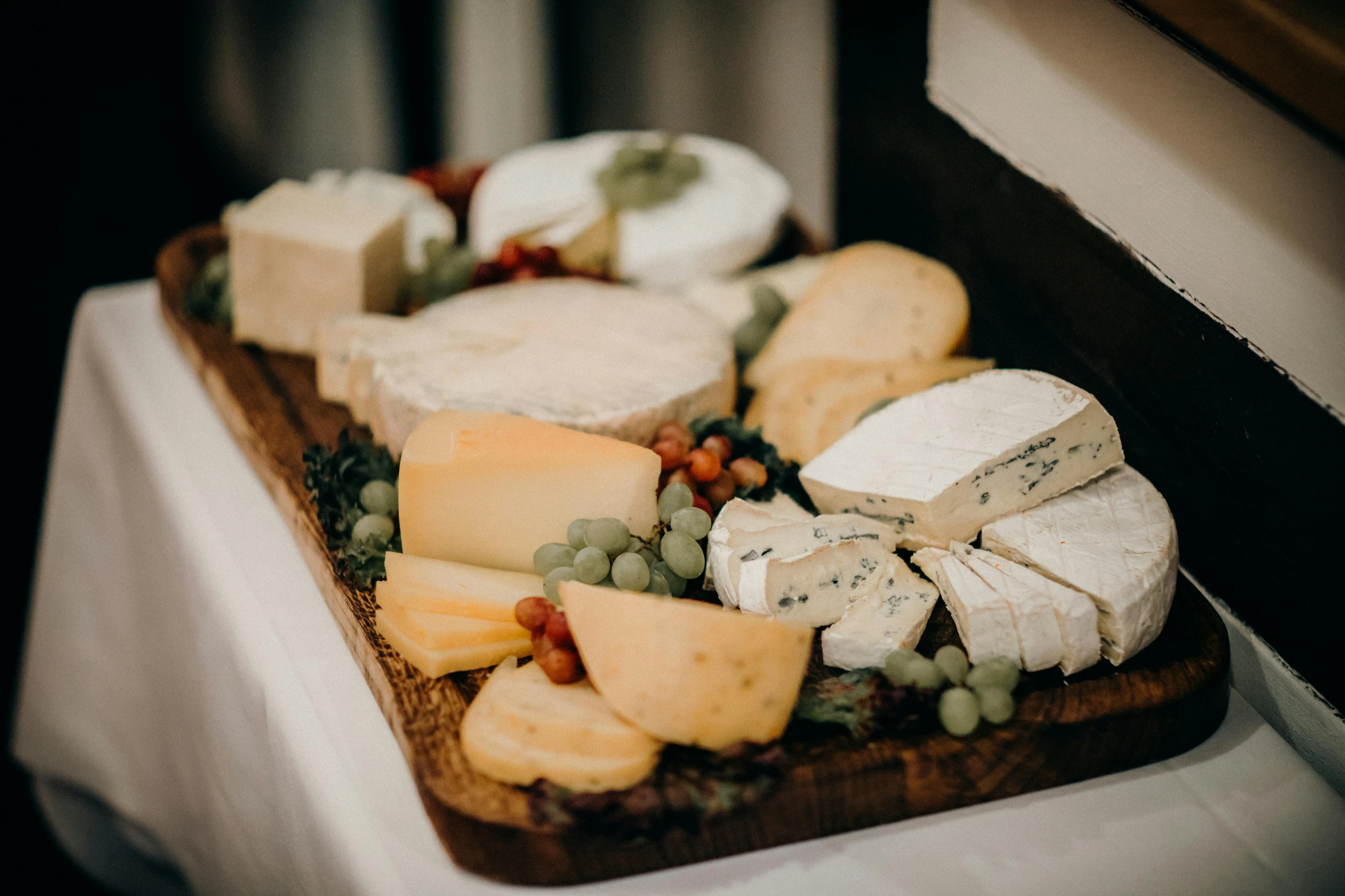 various types of cheese are placed on a board