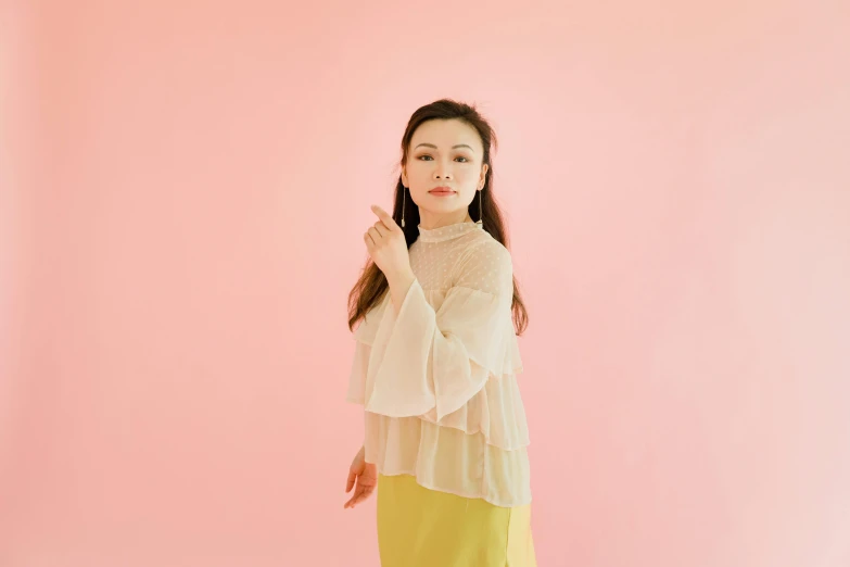 woman in yellow skirt with pink background