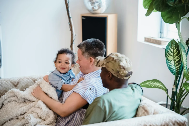 a man with a child and his mom smiling