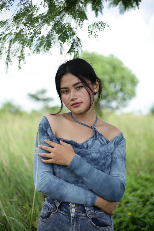 a woman with her arms crossed and looking off into the distance