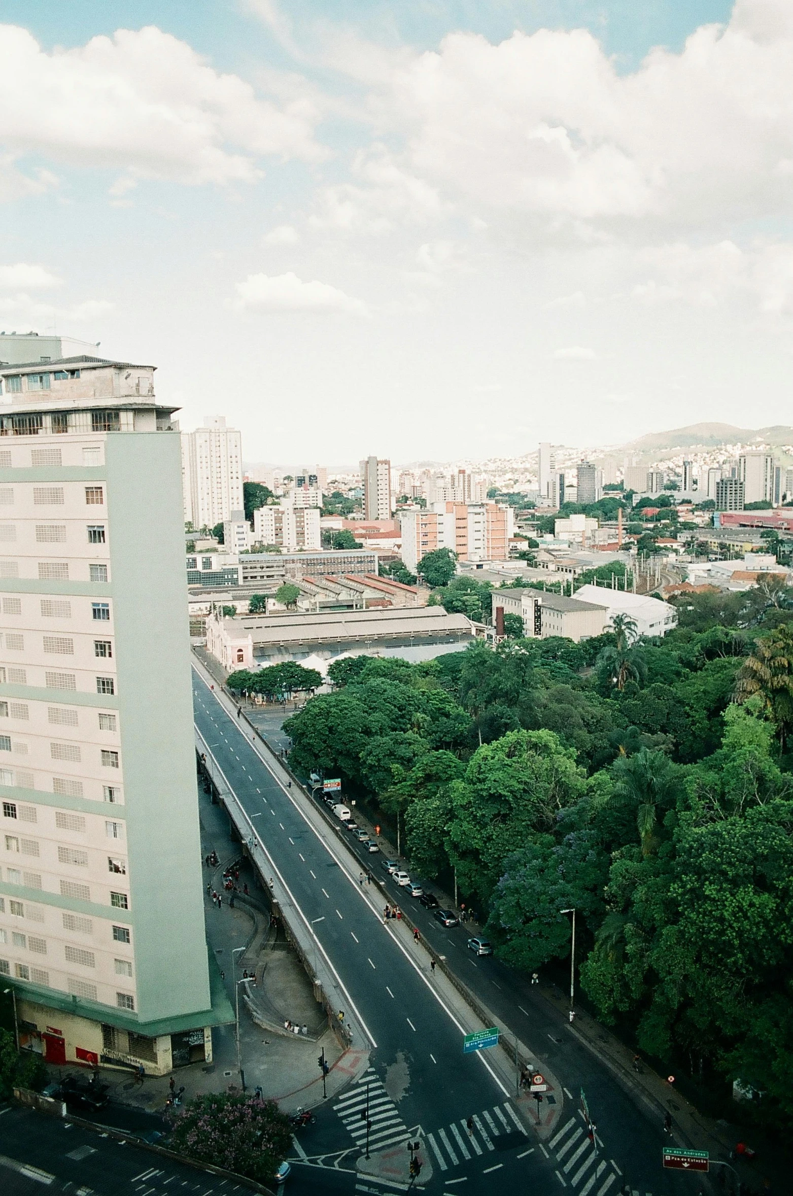 a big city with lots of tall buildings and a few cars driving down it