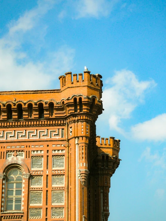 the side view of an old brick building in front of a blue sky