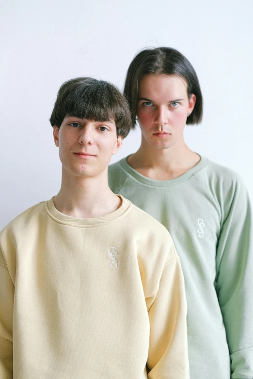 two teenage girls with dark hair posing for the camera