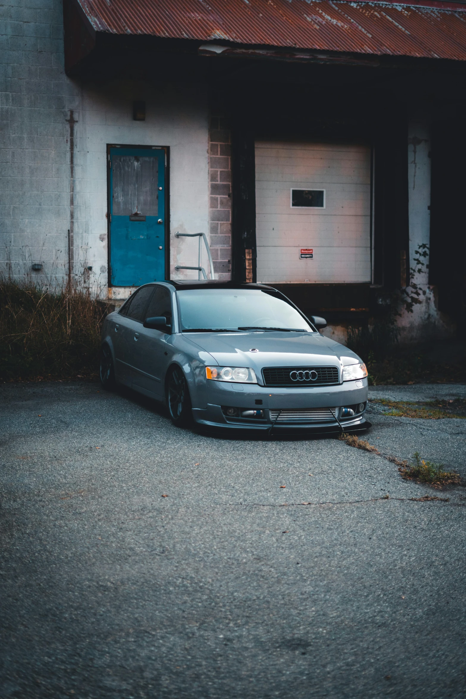 there is a grey car that is parked in front of a house