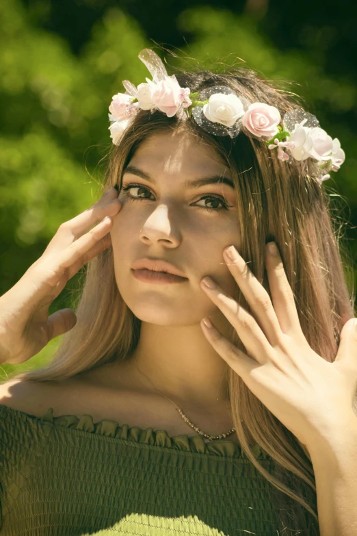 a young woman in a wreath with flowers on her head