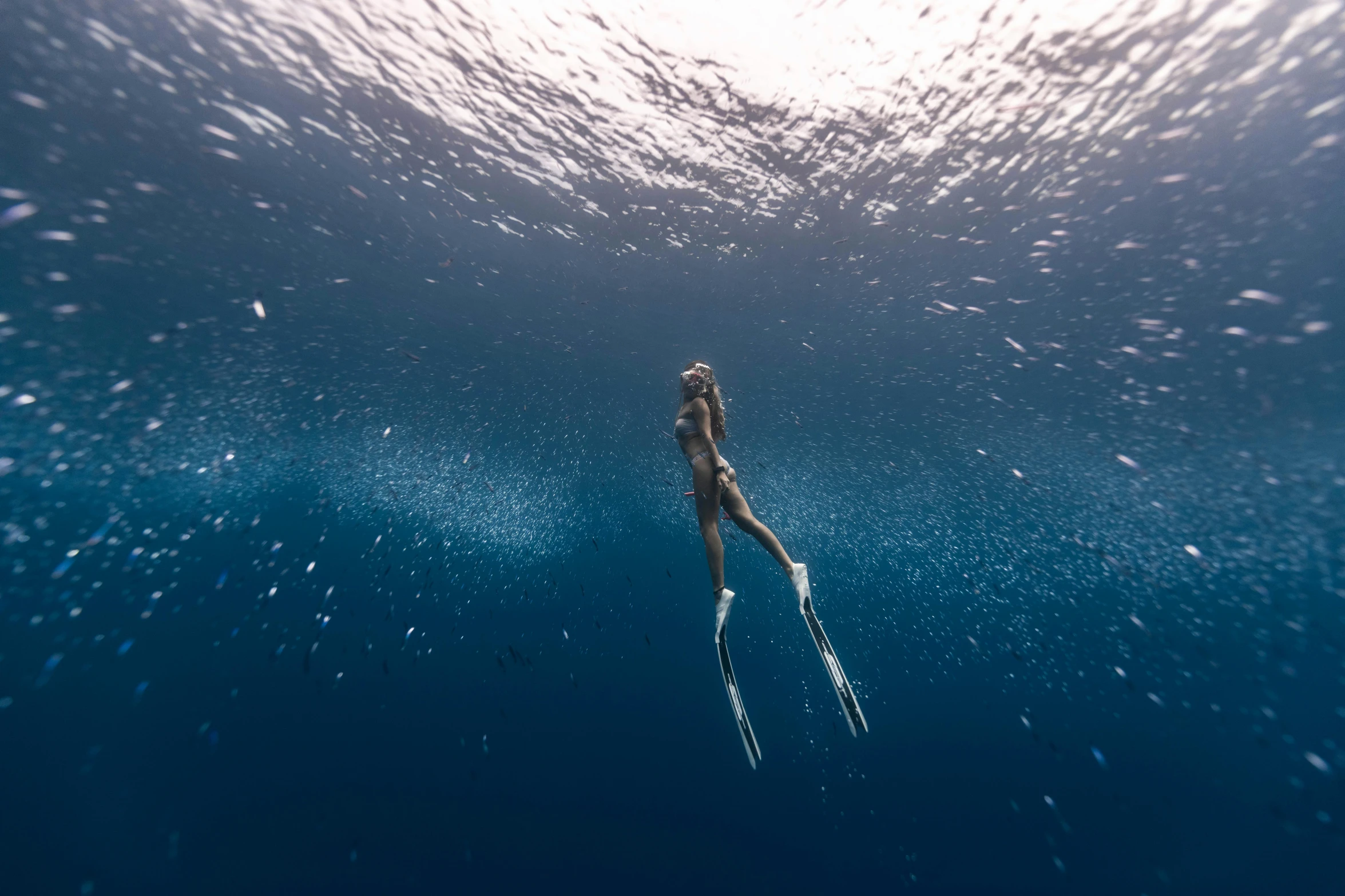 a woman is swimming with snorkels in the water