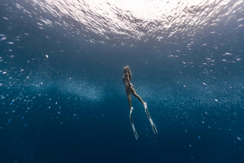 a woman is swimming with snorkels in the water