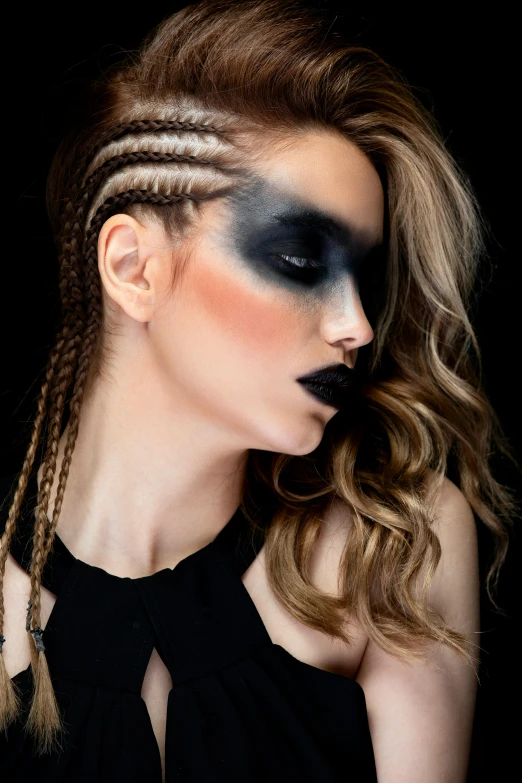 young woman with her face painted black and white