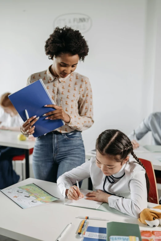 a woman is helping a  with their homework