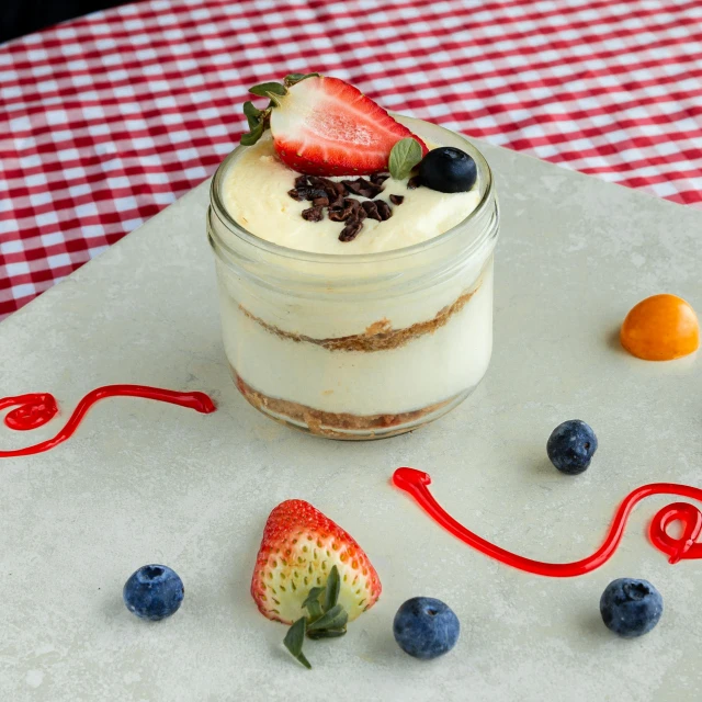 a bowl of food with berries next to it on a table