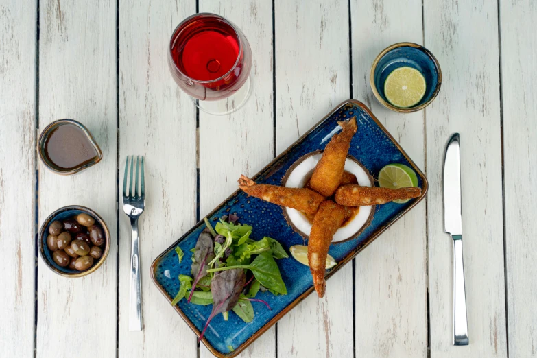 a blue plate with food on it next to other foods